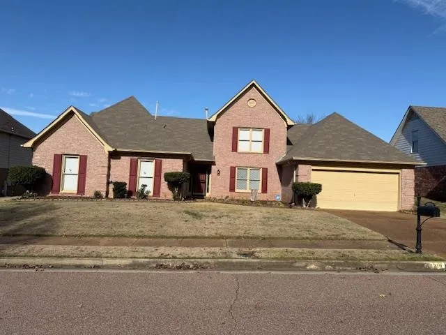 a view of a house with a yard and garage