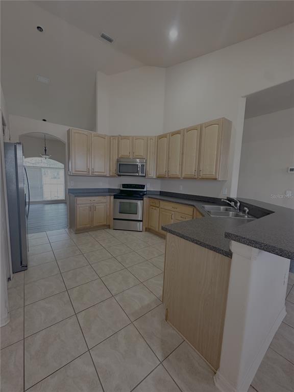 2797 Babbitt Avenue Orlando, FL 32833 - Photo 7 of 10 a kitchen with a sink a stove and cabinets
