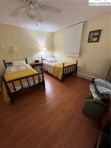 a bedroom with bed and a chandelier