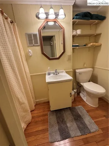a bathroom with a sink toilet and mirror