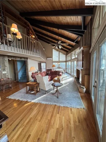 a view of a porch with furniture and a fireplace