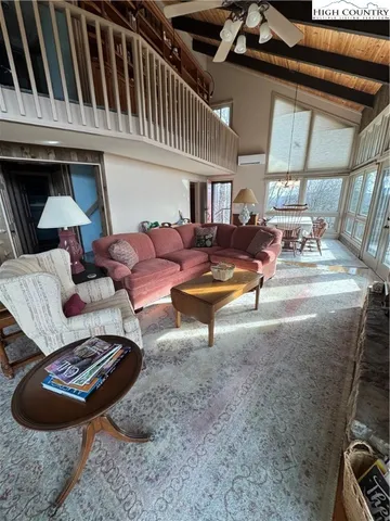 a living room with furniture a rug and a window