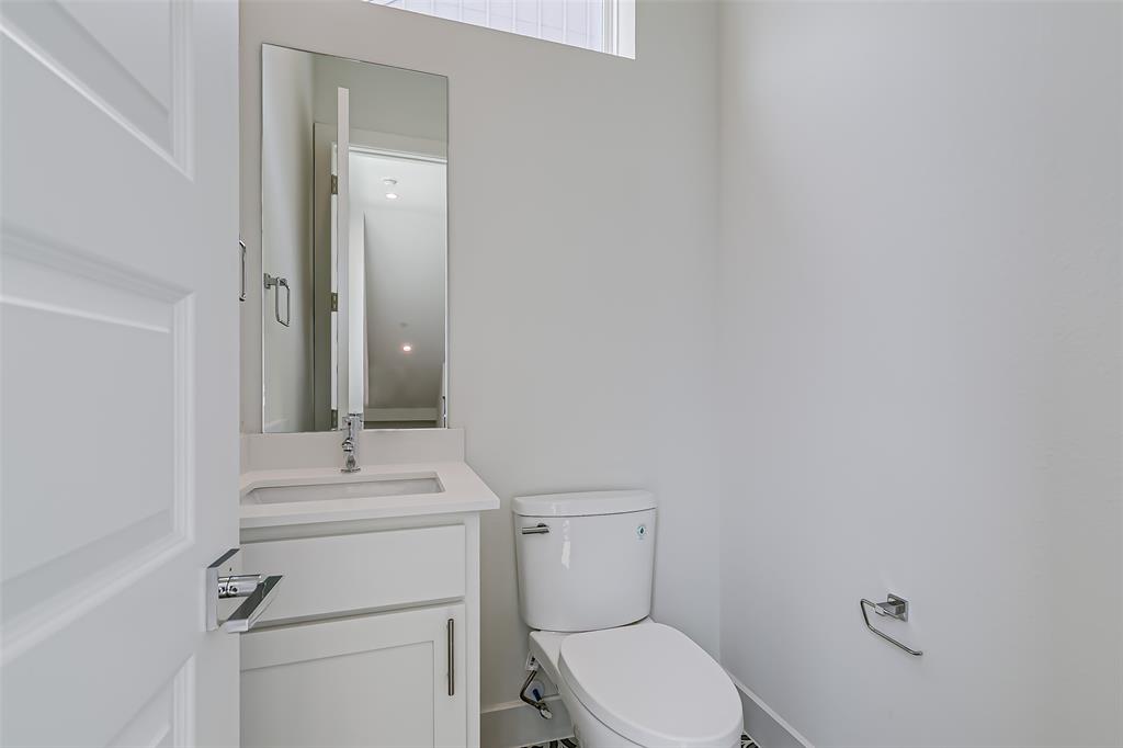 6028 Lewis Street, Unit 202 Dallas, TX 75206 - Photo 13 of 37 a bathroom with a sink mirror vanity and toilet
