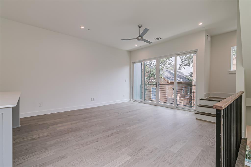 6028 Lewis Street, Unit 202 Dallas, TX 75206 - Photo 16 of 37 an empty room with wooden floor and windows