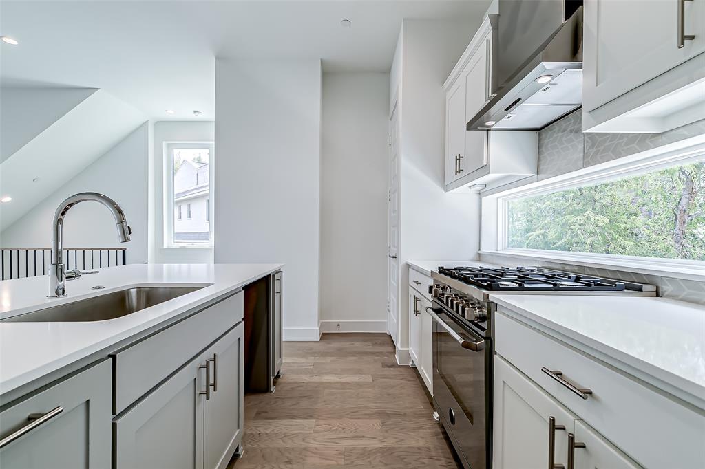 6028 Lewis Street, Unit 202 Dallas, TX 75206 - Photo 21 of 37 a kitchen with granite countertop a stove and a sink