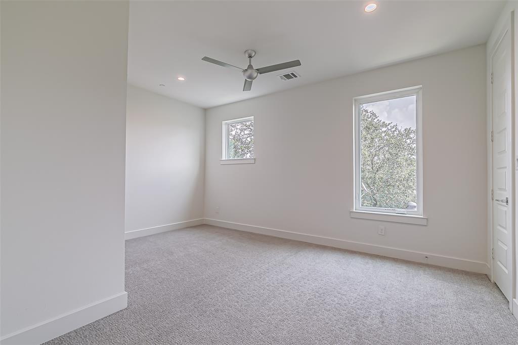 6028 Lewis Street, Unit 202 Dallas, TX 75206 - Photo 30 of 37 an empty room with a window and a ceiling fan