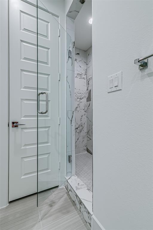 6028 Lewis Street, Unit 202 Dallas, TX 75206 - Photo 35 of 37 a bathroom with a glass shower door