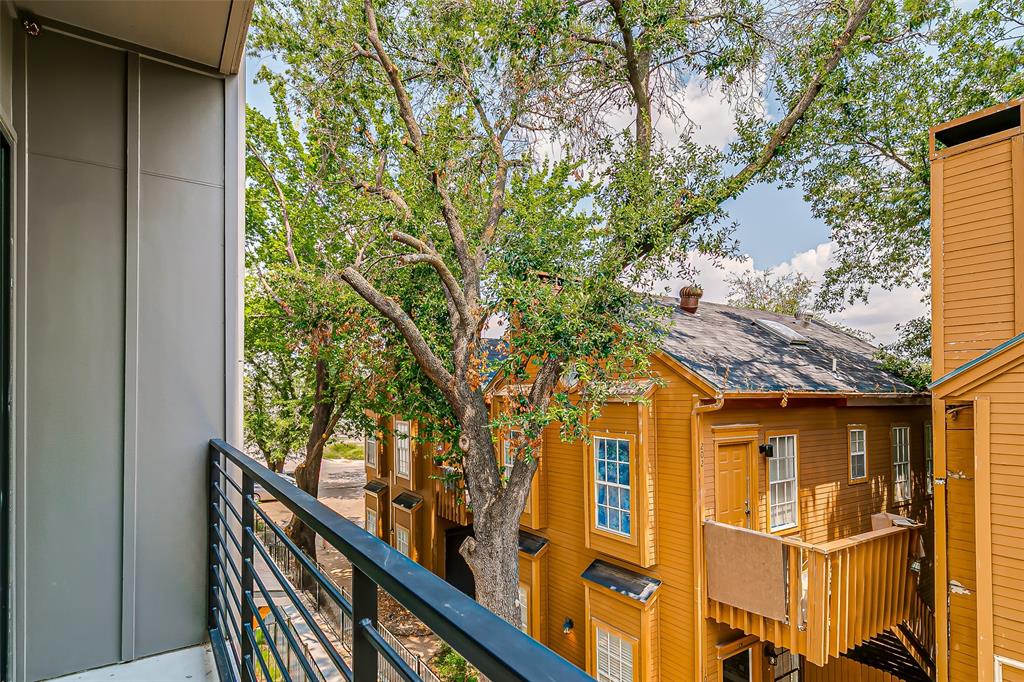 6028 Lewis Street, Unit 202 Dallas, TX 75206 - Photo 37 of 37 a view of a large building with large tree and wooden fence