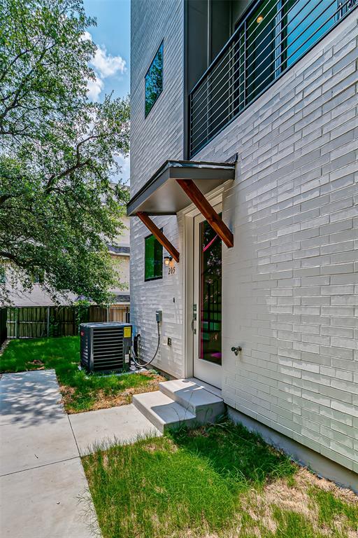 6028 Lewis Street, Unit 202 Dallas, TX 75206 - Photo 6 of 37 a front view of a house with a garden