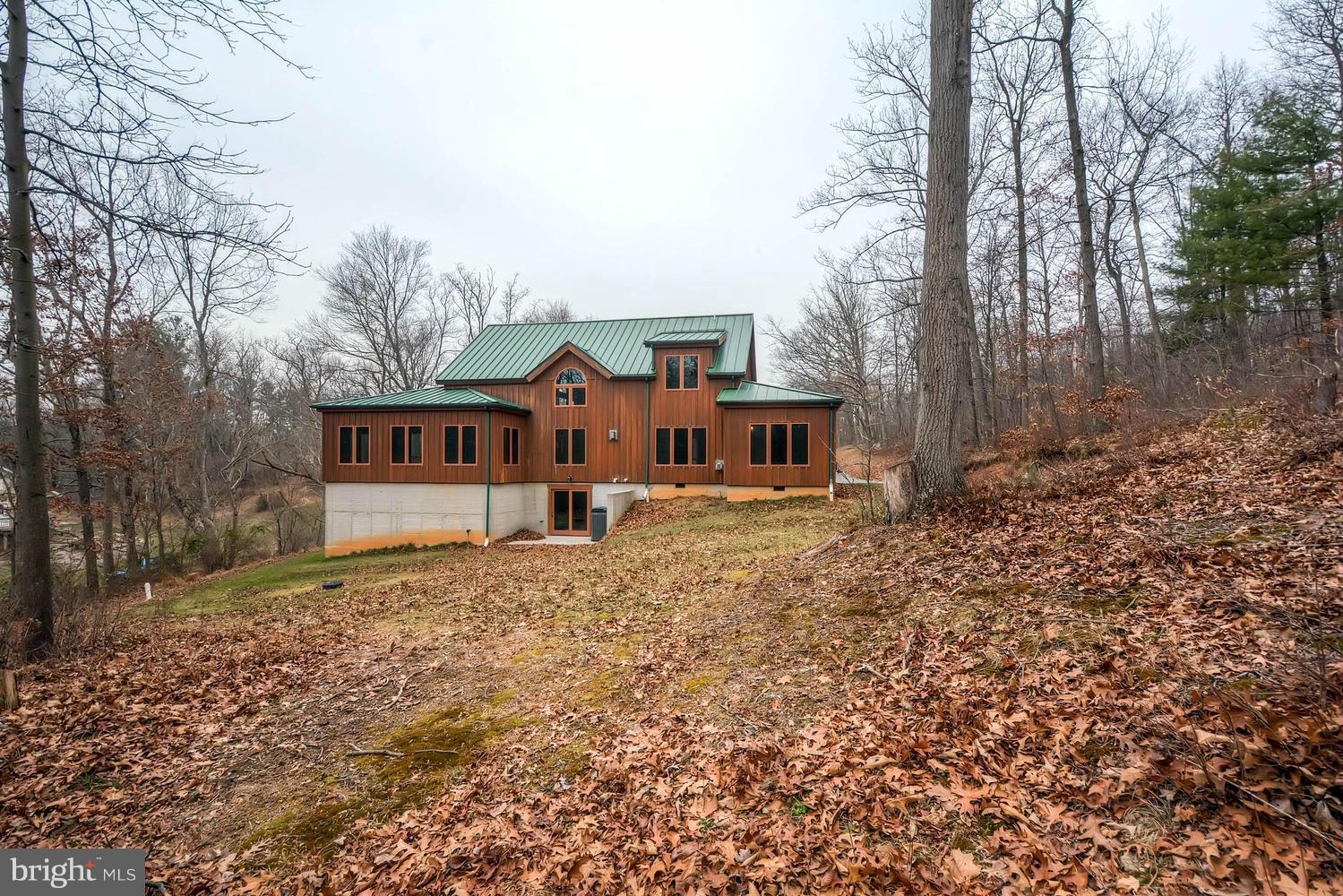 721 Lees Mill Road Upperco, MD 21155 - Photo 15 of 16 a front view of a house with a yard and garage