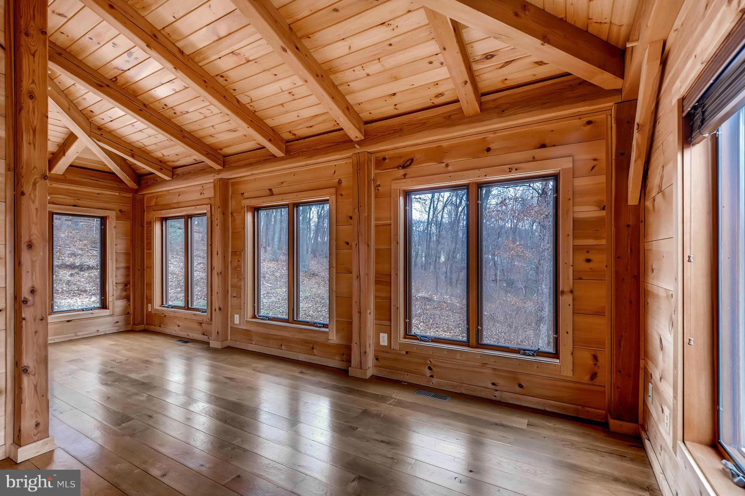 721 Lees Mill Road Upperco, MD 21155 - Photo 9 of 16 a view of an empty room with wooden floor and windows