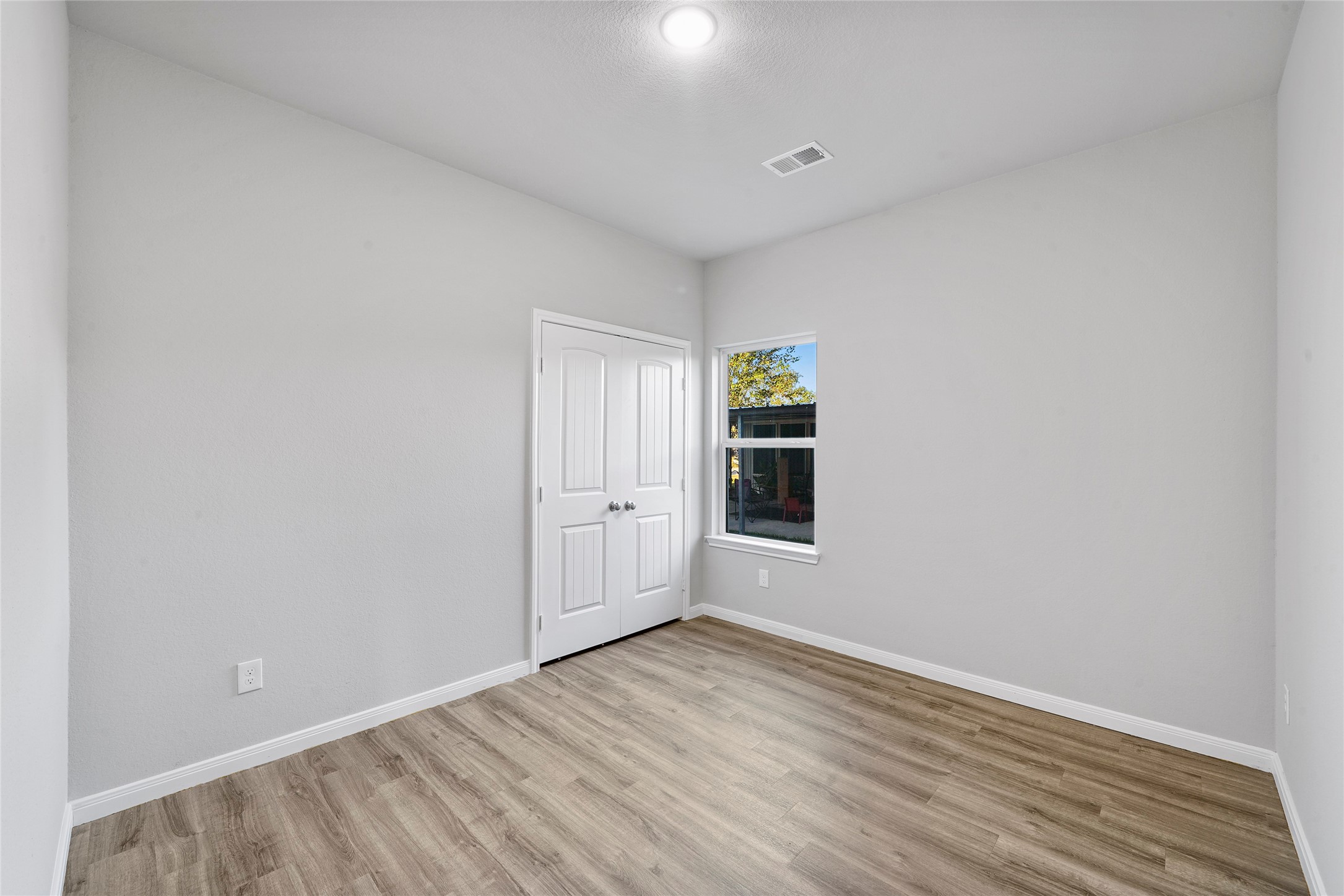 222 Spruce Lake Road Houston, TX 77336 - Photo 14 of 21 a view of an empty room with wooden floor and a window