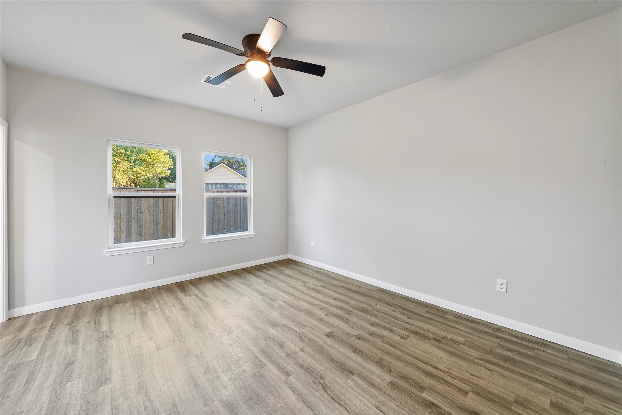 222 Spruce Lake Road Houston, TX 77336 - Photo 16 of 21 wooden floor in an empty room with a window