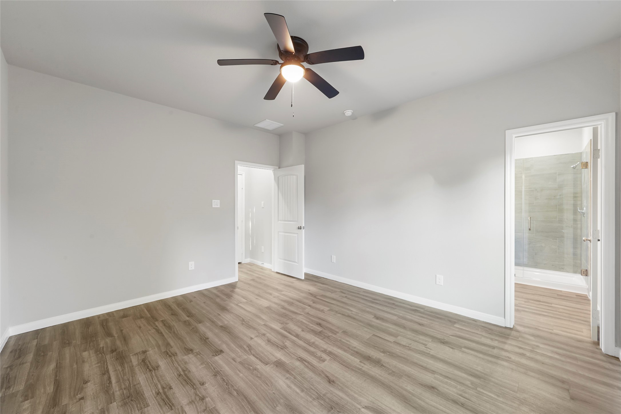 222 Spruce Lake Road Houston, TX 77336 - Photo 17 of 21 an empty room with wooden floor and a ceiling fan