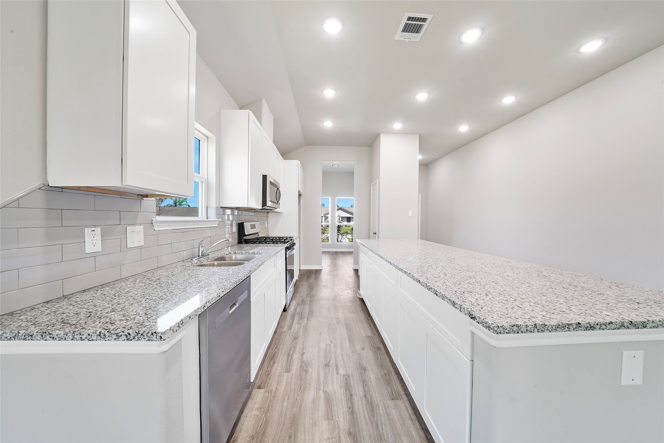 222 Spruce Lake Road Houston, TX 77336 - Photo 2 of 21 a large kitchen with kitchen island granite countertop a sink a stove and a wooden floors