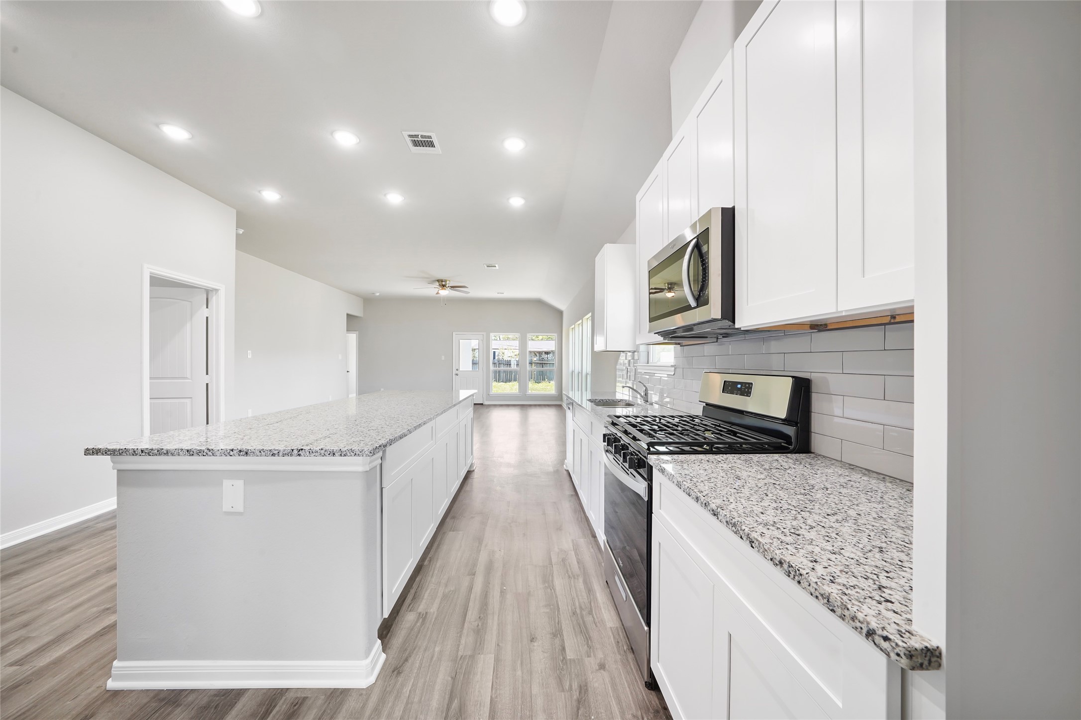 222 Spruce Lake Road Houston, TX 77336 - Photo 6 of 21 a large kitchen with stainless steel appliances granite countertop a large counter top and a stove top oven