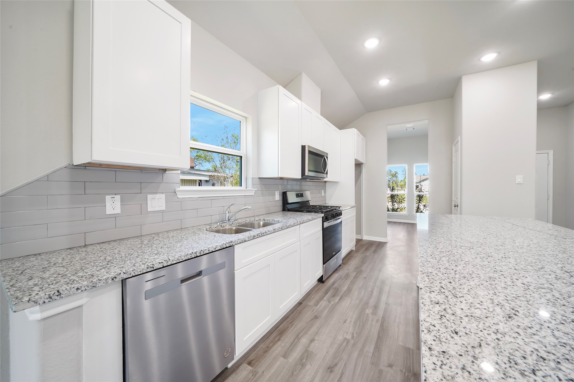 222 Spruce Lake Road Houston, TX 77336 - Photo 8 of 21 a large kitchen with granite countertop a large counter top a sink stainless steel appliances and cabinets