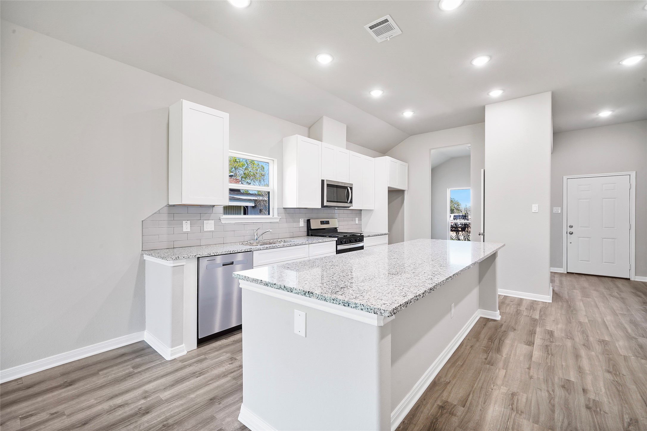 222 Spruce Lake Road Houston, TX 77336 - Photo 9 of 21 a large kitchen with granite countertop a sink counter space and stainless steel appliances