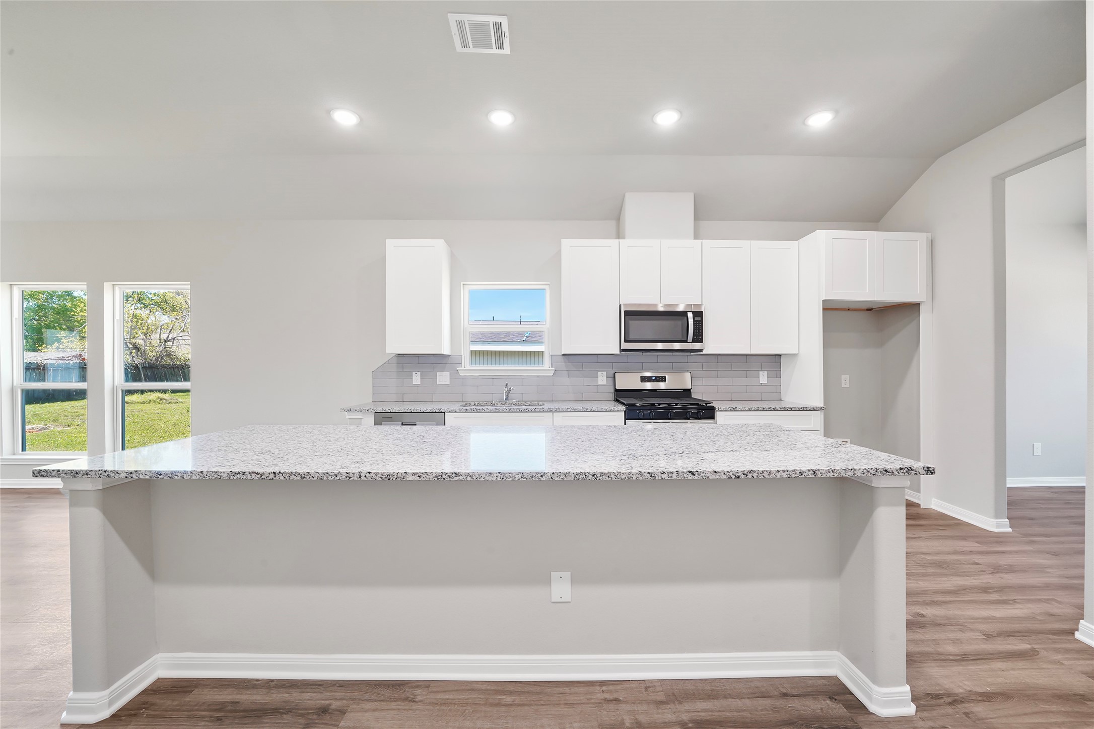 222 Spruce Lake Road Houston, TX 77336 - Photo 10 of 21 a large kitchen with granite countertop a sink a counter top space and stainless steel appliances