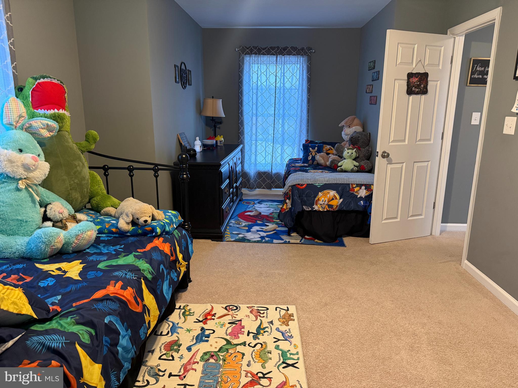 113 State Street Sharptown, MD 21861 - Photo 12 of 18 a bedroom with a bed and a chandelier