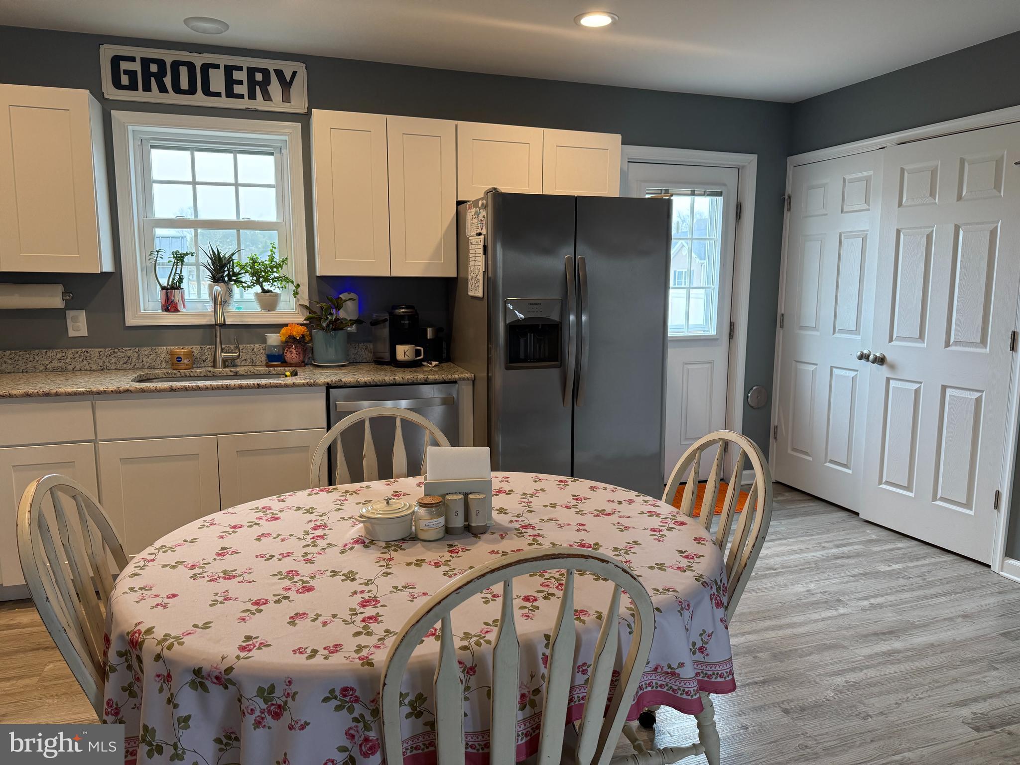 113 State Street Sharptown, MD 21861 - Photo 5 of 18 a kitchen with stainless steel appliances a dining table chairs refrigerator and sink