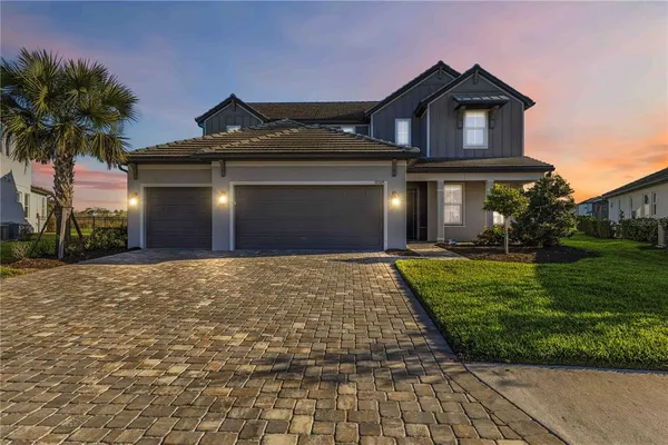 a front view of a house with a yard and garage