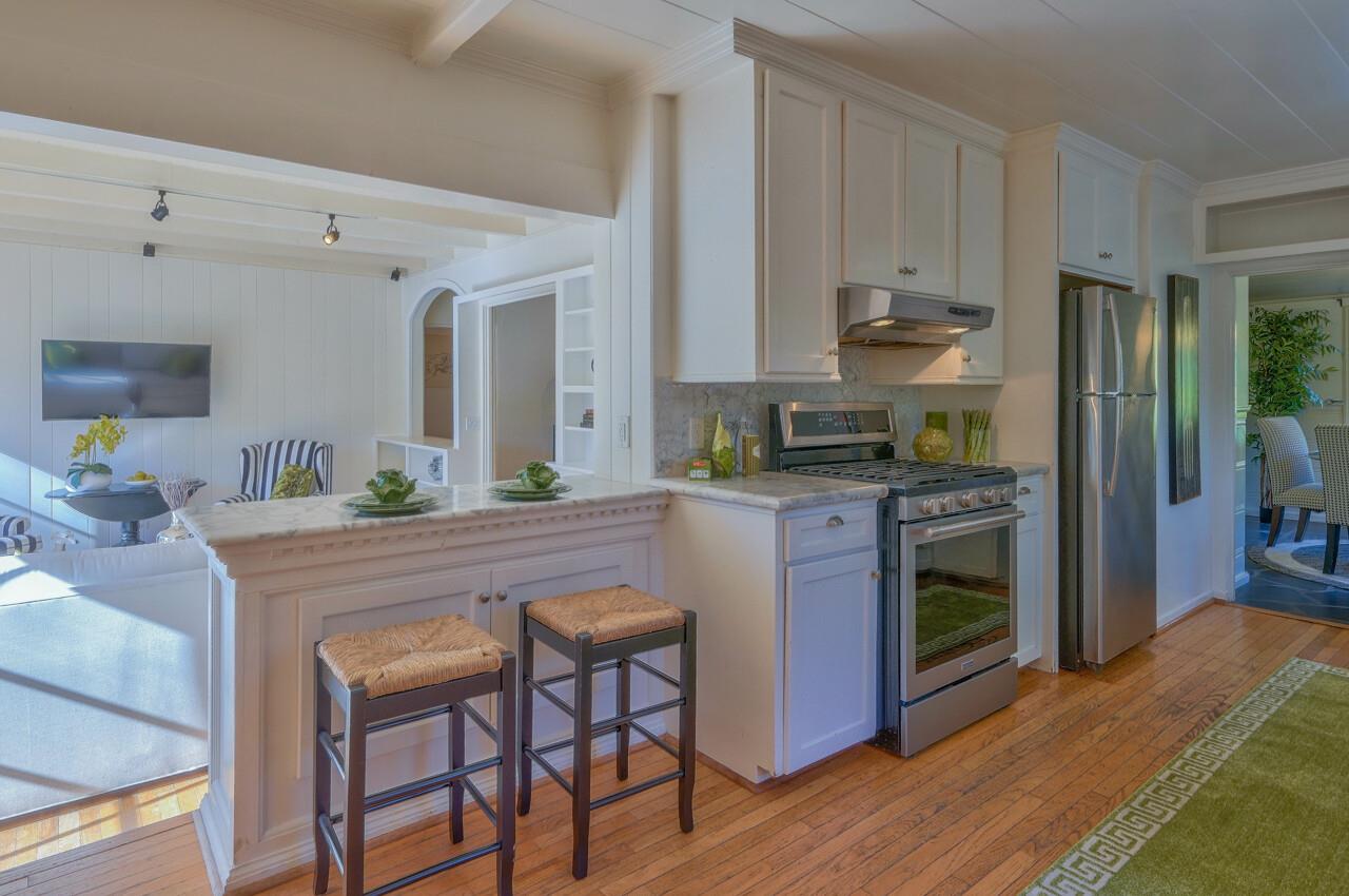24770 Valley Way Carmel, CA 93923 - Photo 11 of 39 a kitchen with kitchen island granite countertop wooden floors and stainless steel appliances