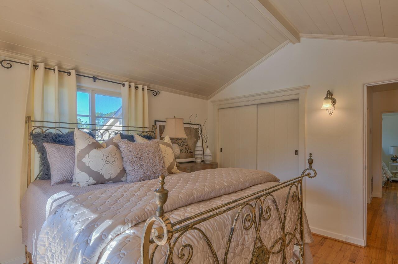 24770 Valley Way Carmel, CA 93923 - Photo 19 of 39 a bedroom with a bed and a mirror