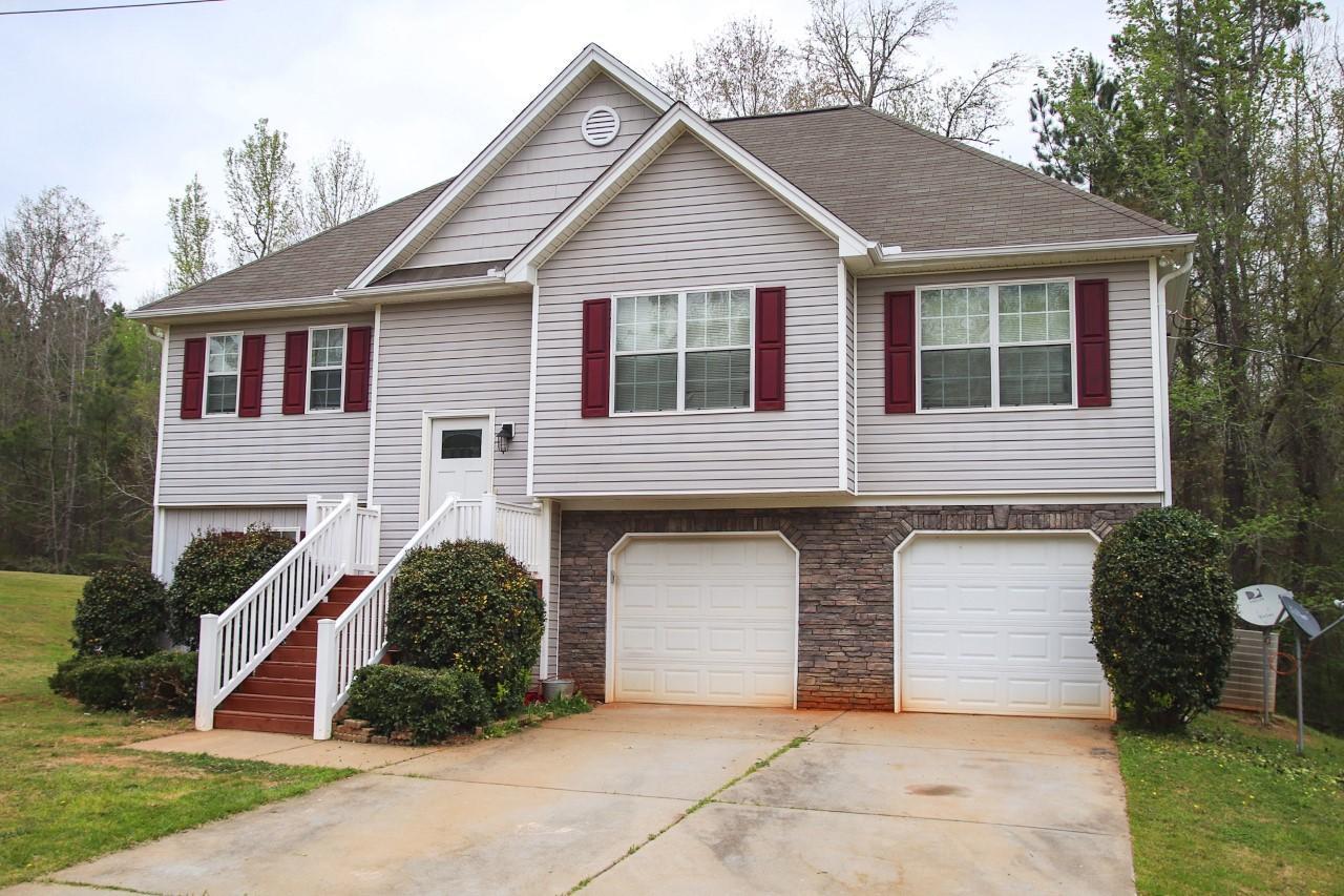 3369 Trotters Ridge Trail Gray, GA 31032 - Photo 1 of 13 a front view of a house with a yard and garage