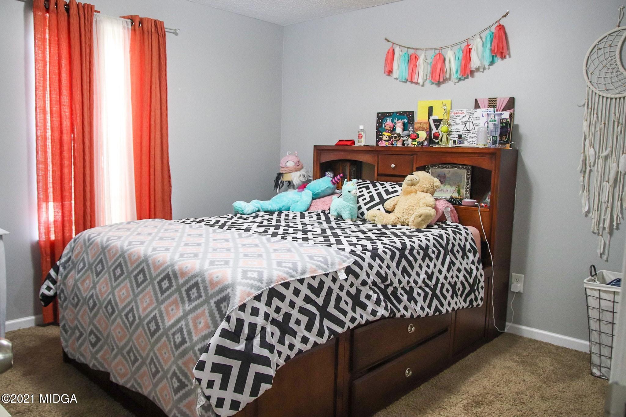 3369 Trotters Ridge Trail Gray, GA 31032 - Photo 13 of 13 a bedroom with a bed and window