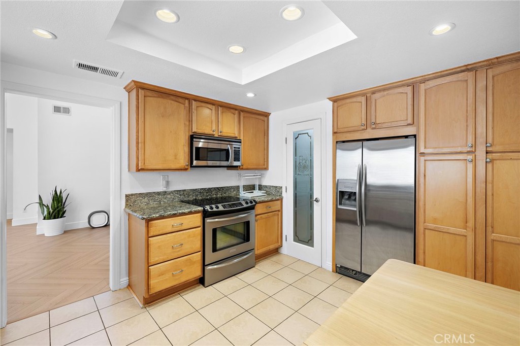18 Navarre, Unit 133 Irvine, CA 92612 - Photo 11 of 32 a kitchen with stainless steel appliances a refrigerator sink and stove