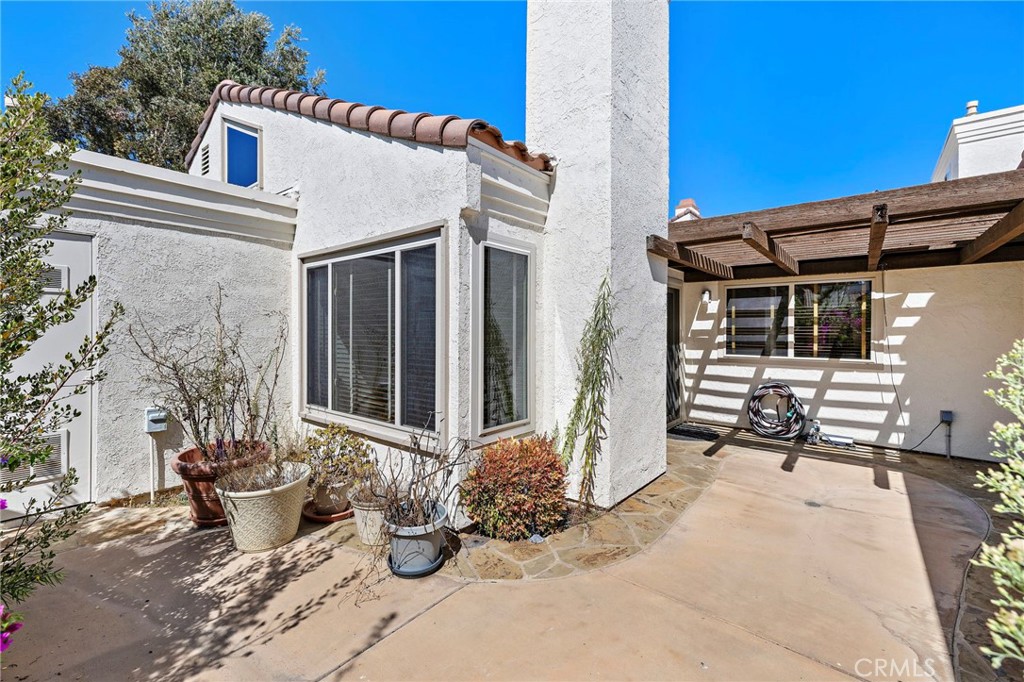 18 Navarre, Unit 133 Irvine, CA 92612 - Photo 20 of 32 a view of a patio with table and chairs and potted plants