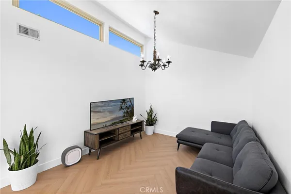 a living room with furniture and a chandelier