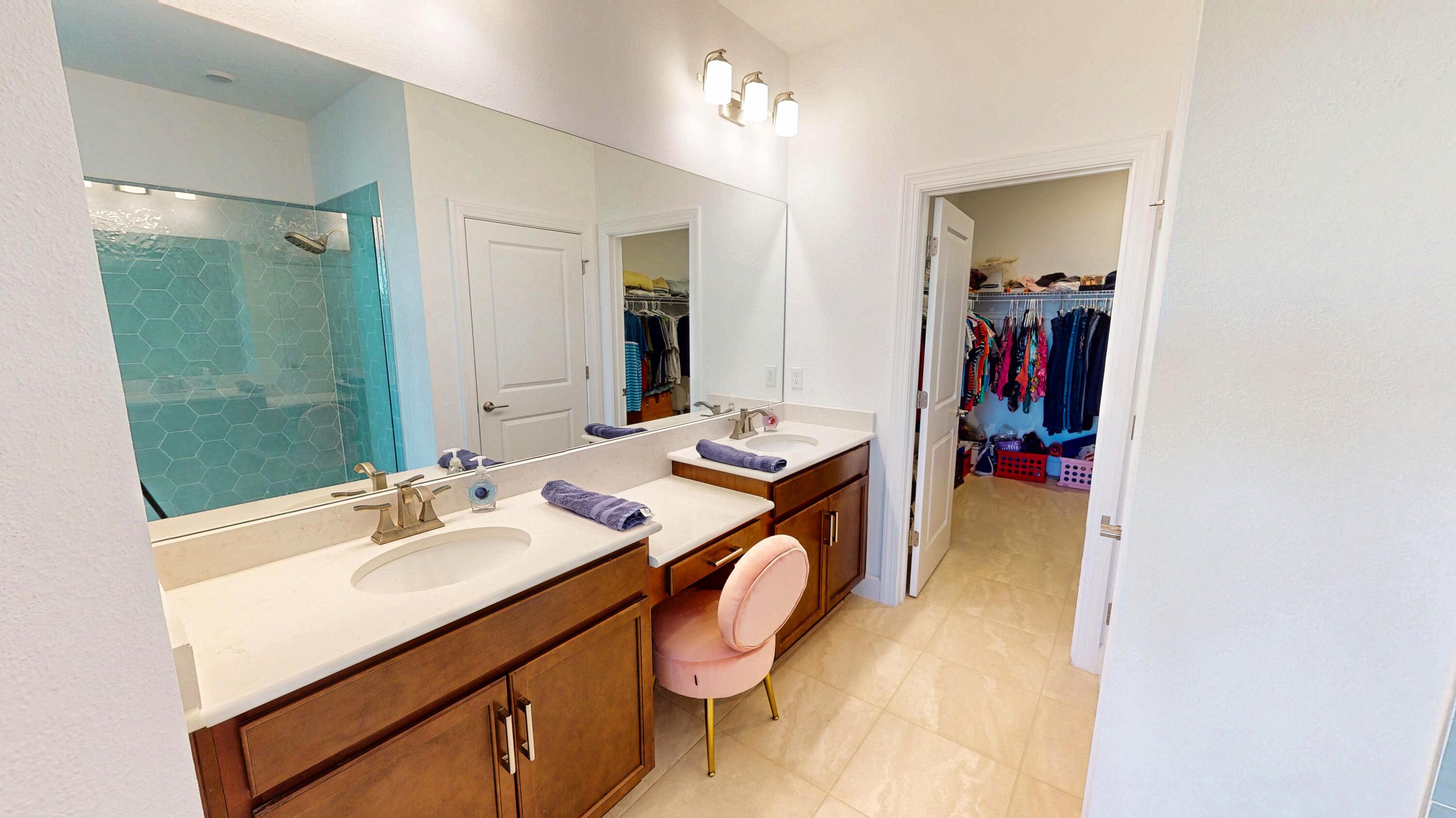 9876 Santini Road Port St. Lucie, FL 34987 - Photo 12 of 45 a en suite bathroom with a sink double vanity and a mirror