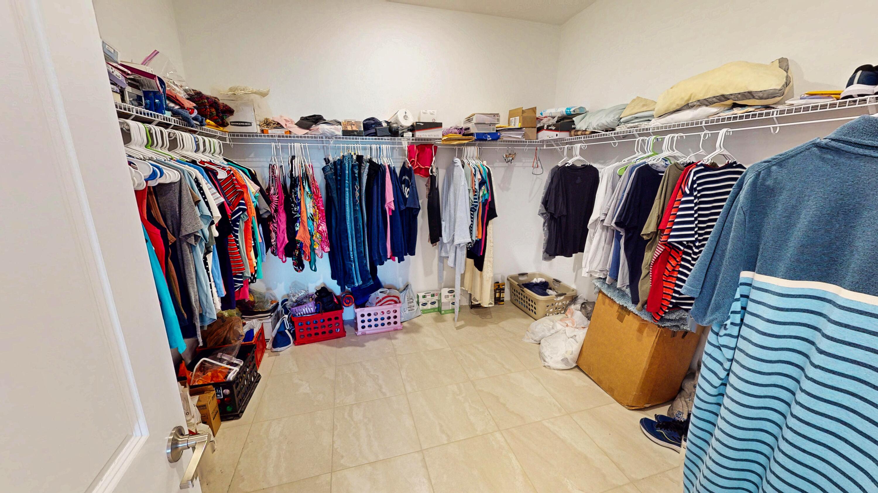 9876 Santini Road Port St. Lucie, FL 34987 - Photo 13 of 45 a view of walk in closet with clothes