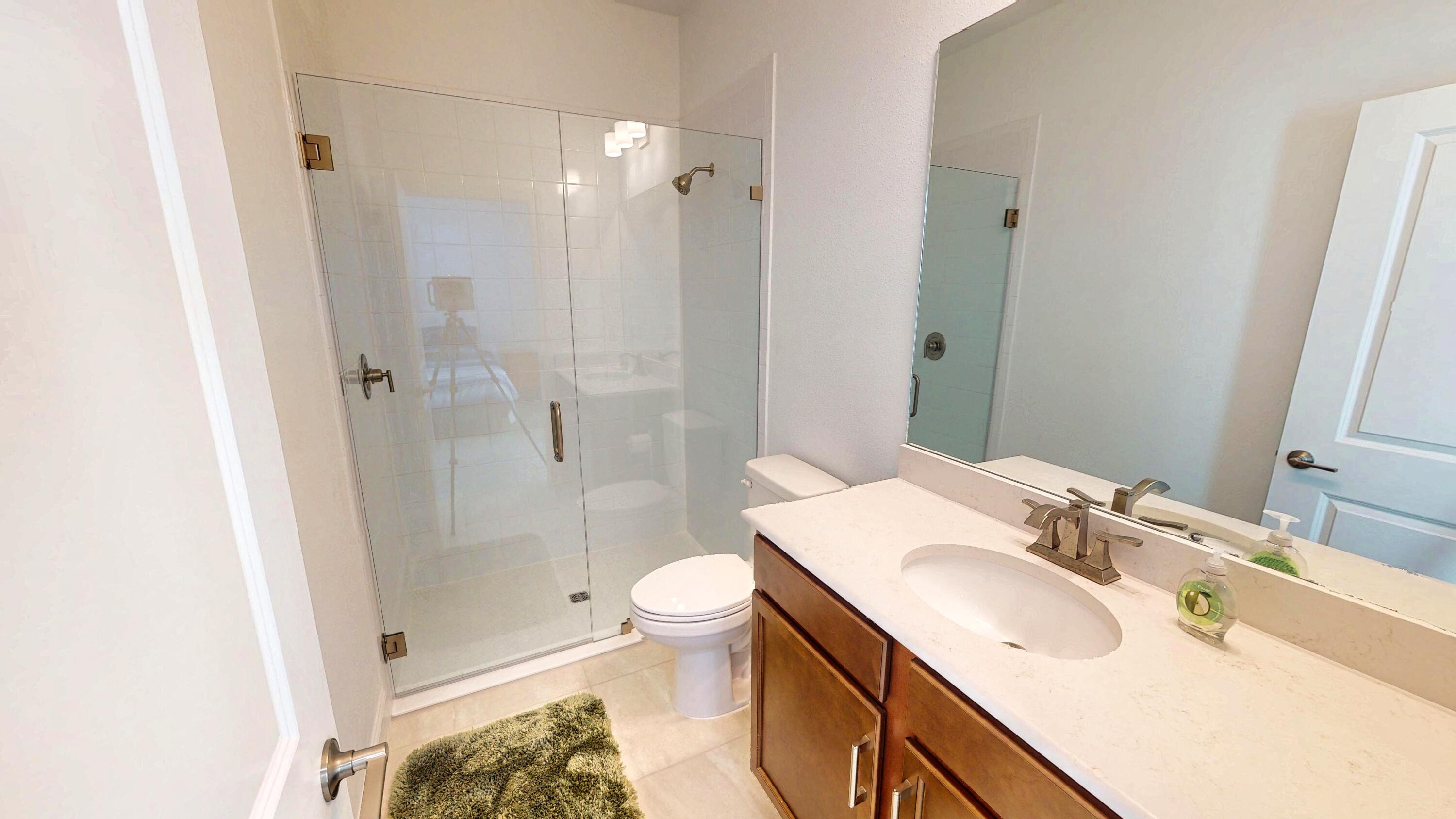 9876 Santini Road Port St. Lucie, FL 34987 - Photo 18 of 45 a bathroom with a sink toilet and shower