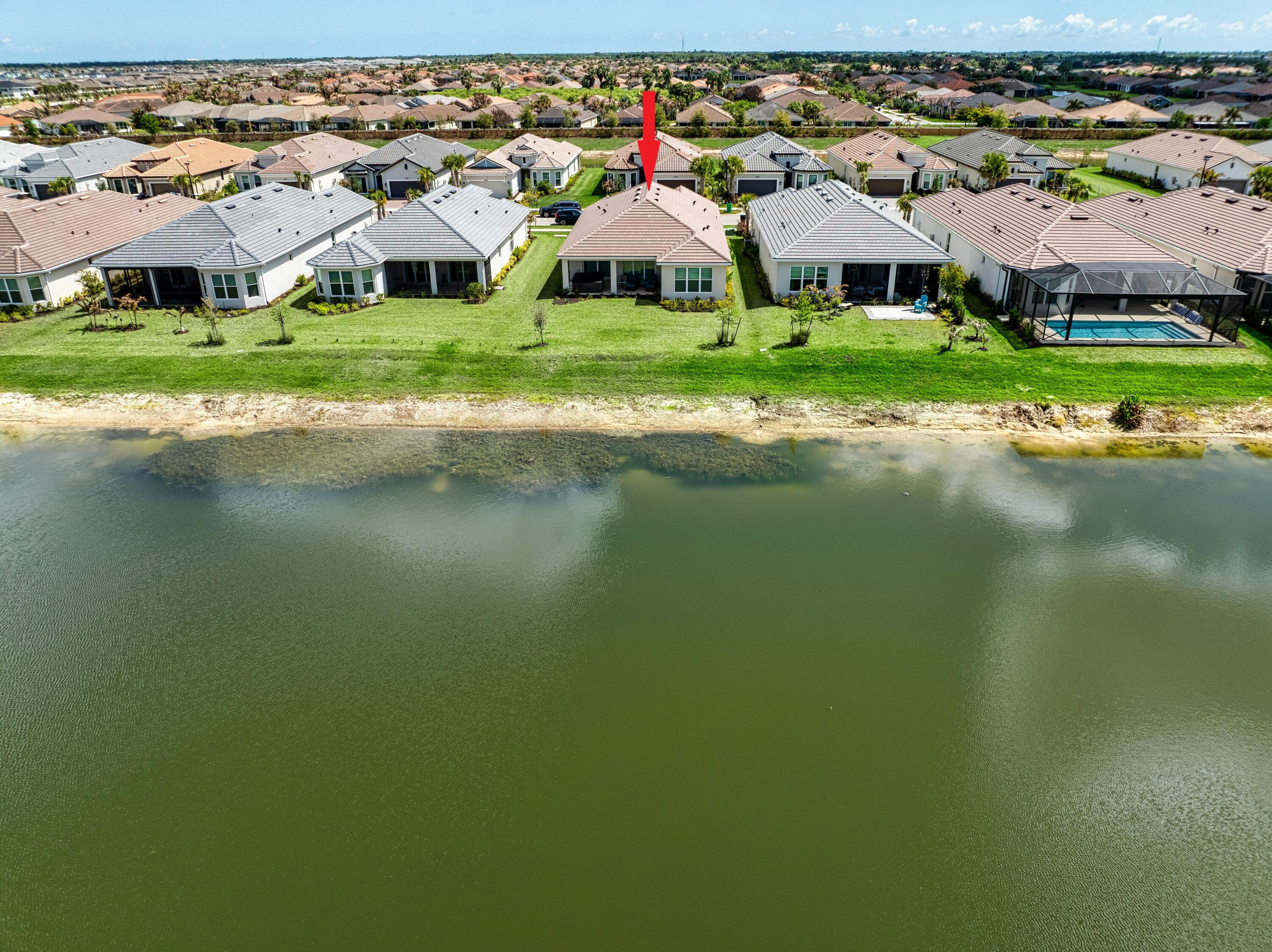 9876 Santini Road Port St. Lucie, FL 34987 - Photo 28 of 45 a front view of a house with a yard and lake view