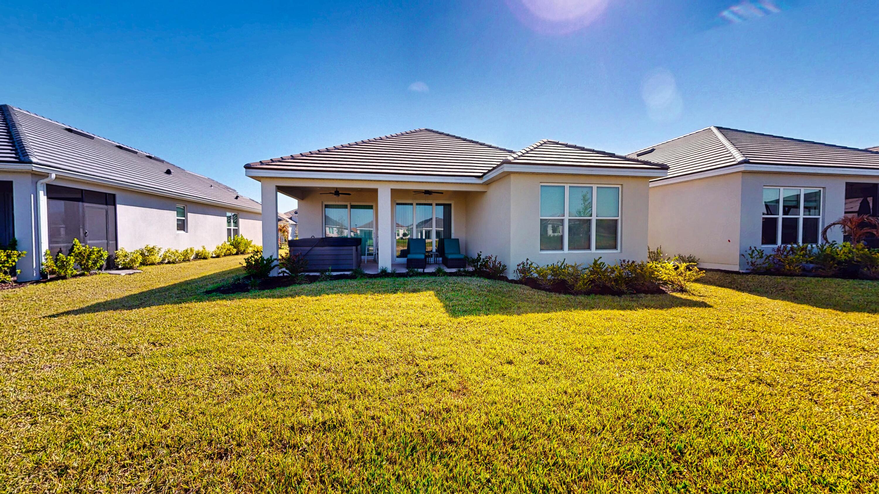 9876 Santini Road Port St. Lucie, FL 34987 - Photo 32 of 45 a front view of house with yard and seating area