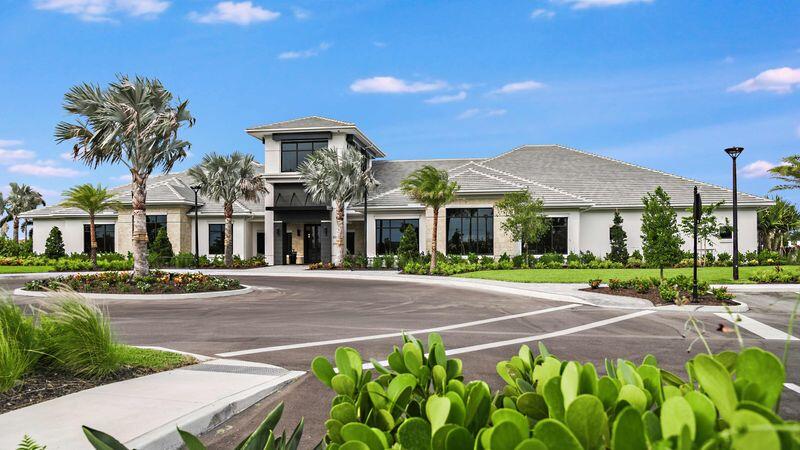 9876 Santini Road Port St. Lucie, FL 34987 - Photo 35 of 45 a front view of a building with a garden