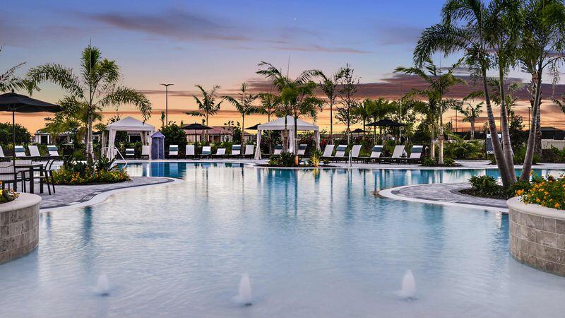 9876 Santini Road Port St. Lucie, FL 34987 - Photo 38 of 45 a view of a swimming pool with a table and chairs