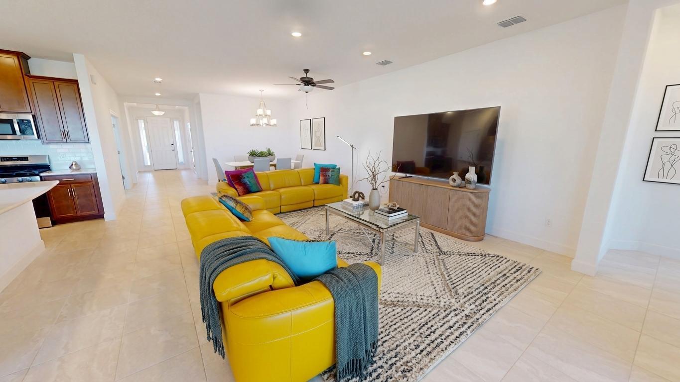9876 Santini Road Port St. Lucie, FL 34987 - Photo 9 of 45 a living room with furniture and a flat screen tv