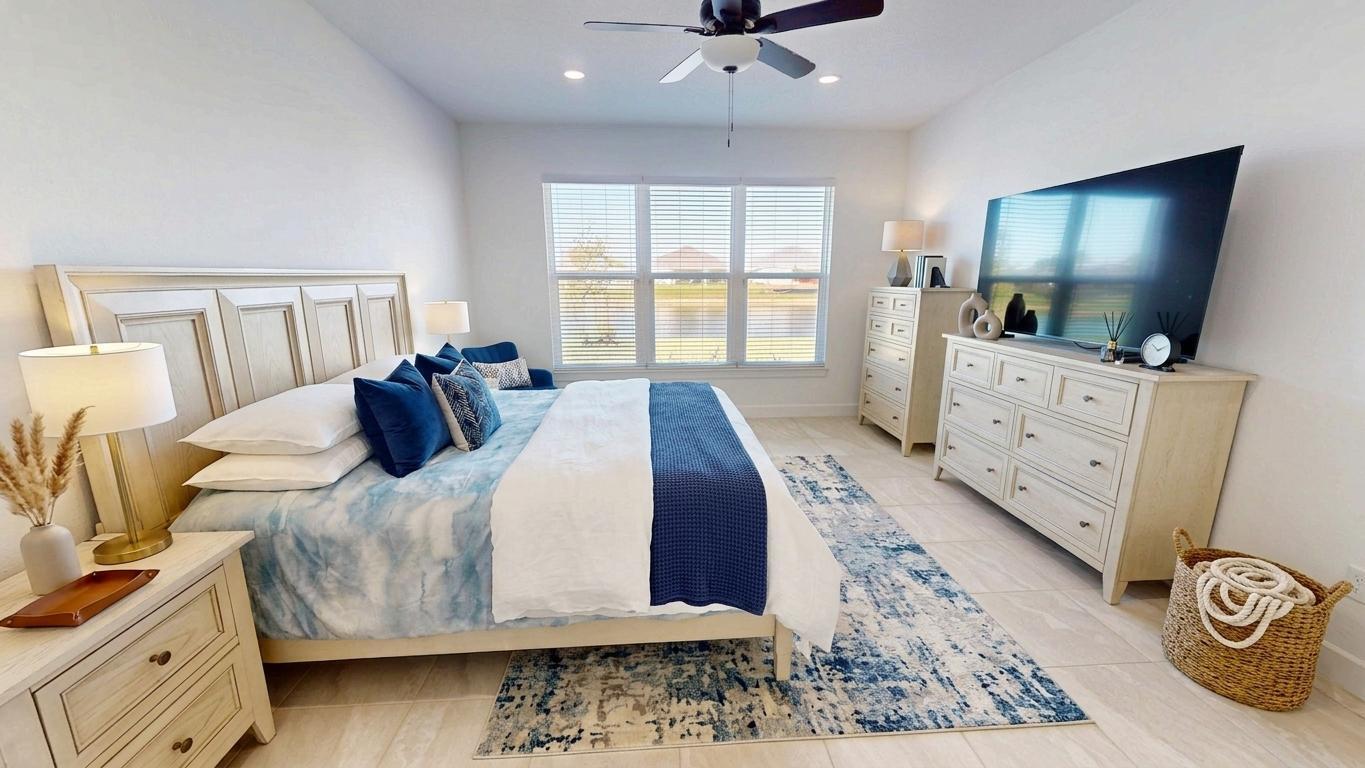 9876 Santini Road Port St. Lucie, FL 34987 - Photo 10 of 45 a bedroom with a bed and a flat screen tv