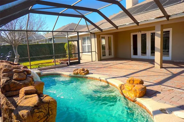 a view of a swimming pool with a yard