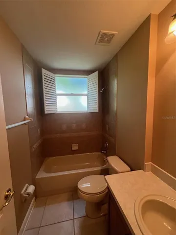 a bathroom with a sink a toilet and tub