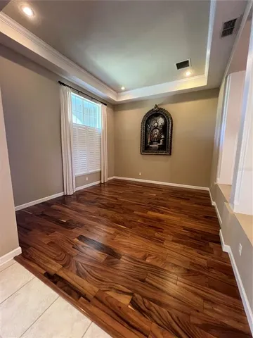 a view of a room with wooden floor and window