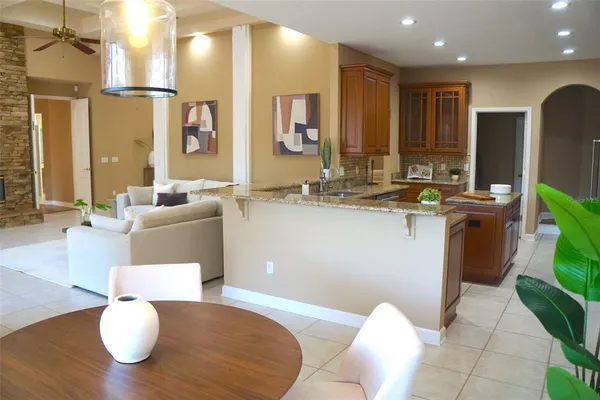 a kitchen with stainless steel appliances granite countertop a sink a microwave cabinets and wooden floor