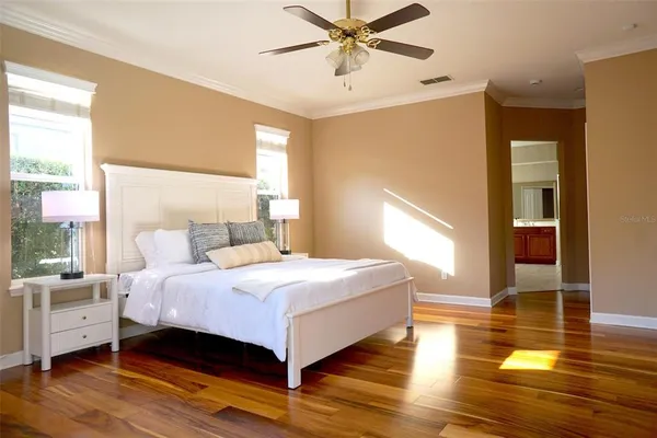 a bedroom with a bed and windows