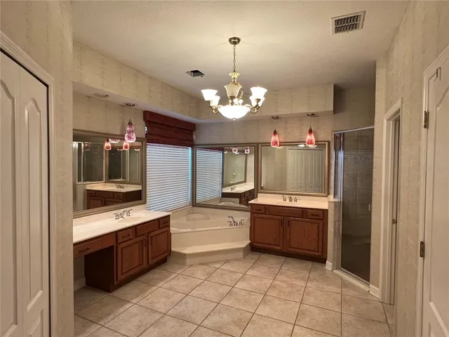 a large white kitchen with a sink and dishwasher a stove with wooden floor