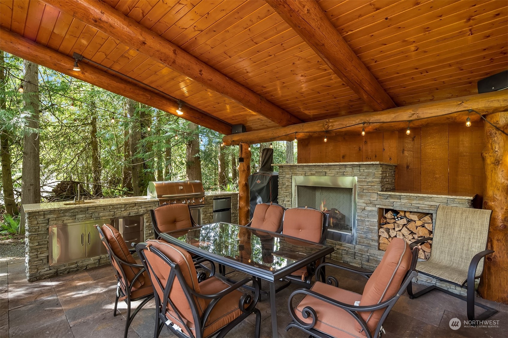 24221 Northeast Union Hill Road Redmond, WA 98053 - Photo 25 of 40 a view of a patio with table and chairs a barbeque with wooden floor and roof