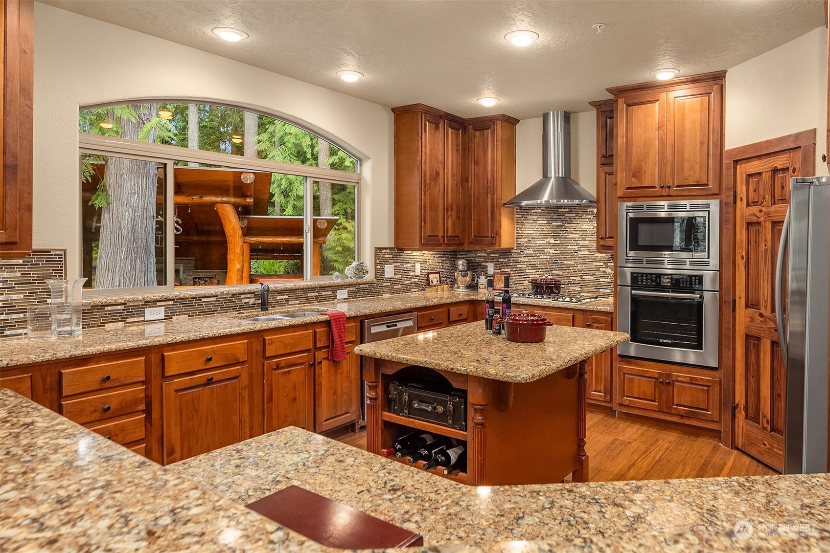 24221 Northeast Union Hill Road Redmond, WA 98053 - Photo 27 of 40 a kitchen with kitchen island granite countertop a sink stove and refrigerator